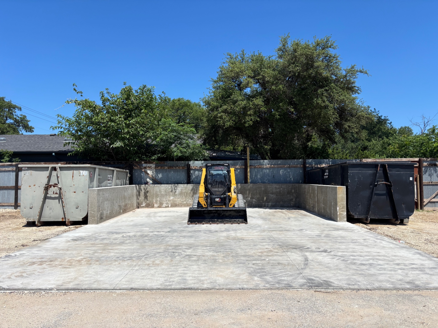 620 Recycling Depot drop-off bay with skid steer and roll-off containers